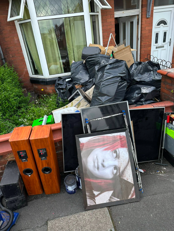 Front garden full of bags, boxes and household items before Vanquish Waste clearance